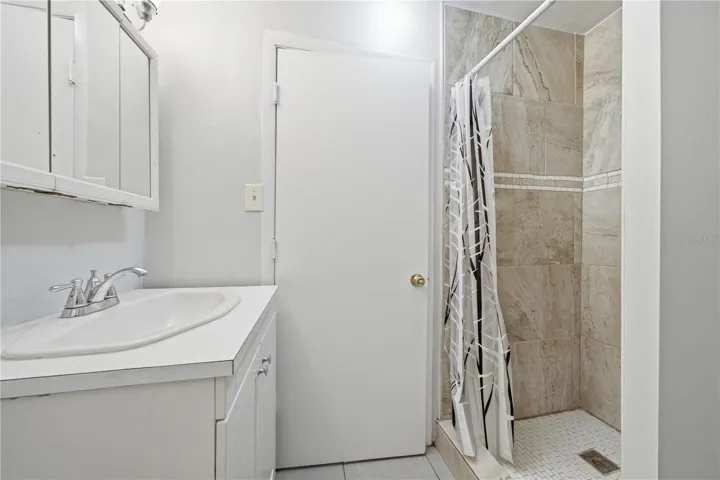 Second bathroom is located off of the kitchen and also includes a space for a stackable washer and dryer