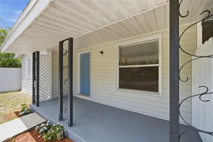 Newly painted front door with covered patio