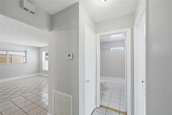 View into the living room and hall access to full bathroom