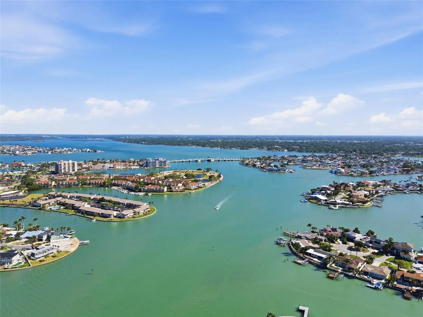 Aerial photo high above 4 Bellevue looking northwest towards Treasure Island Causeway drawbridge allowing access to the Gulf for sailboats and larger motorçboats.