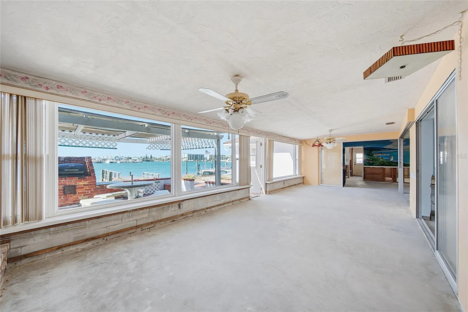 View from the family room looking south towards the turquoise waters of the Intracoastal. The existing kitchen area, living room, dining room, family room and second bedroom have Intracoastal water views.