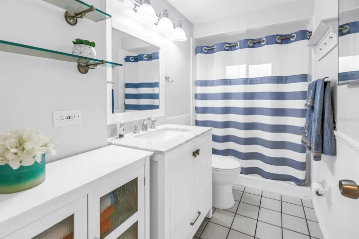 Bathroom features updated vanity and accessible walk-in shower