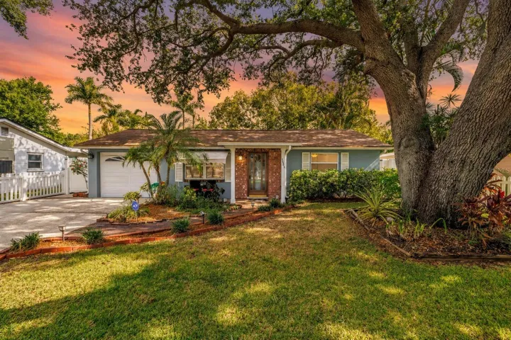 Charming curb appeal beneath a majestic oak canopy welcomes you home