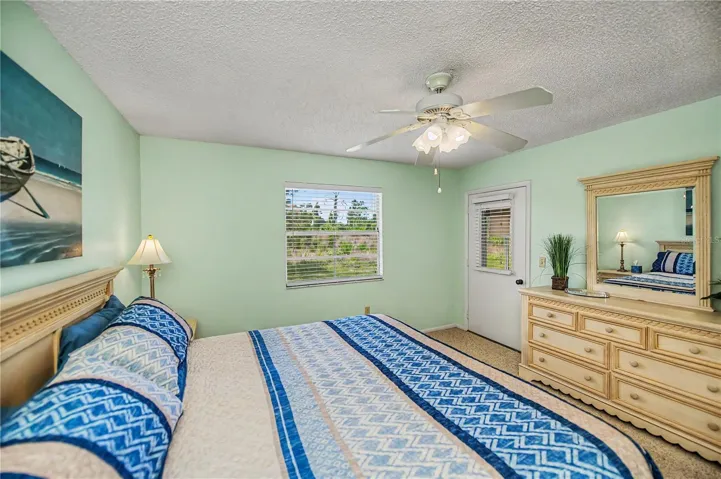 Another view showing the window to the rear and the door onto the lanai.  Beautiful bedroom furnishings included in sale.