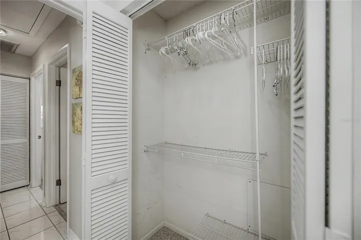 Spacious closet with different levels for dresses, pants and shirts.