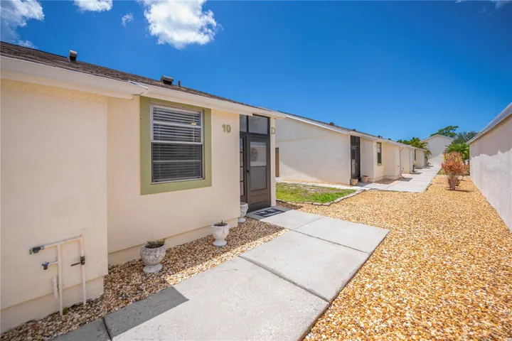 Sidewalk to the unit from the carport