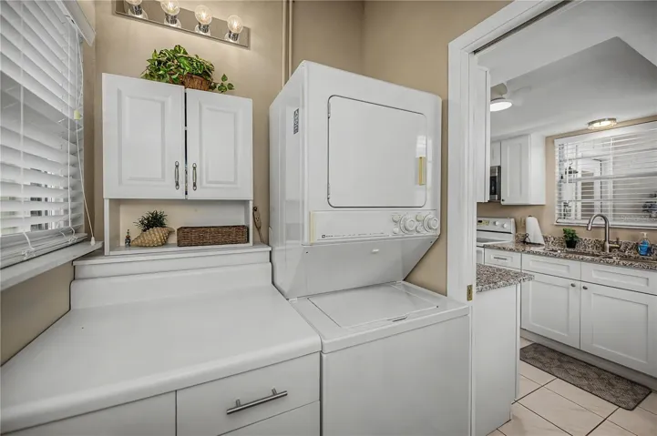 Stackable washer and dryer save space in laundry room.