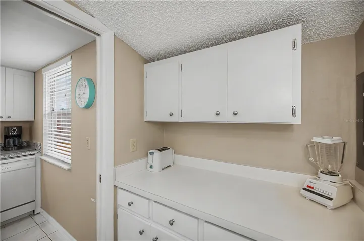 Cabinets and counter in laundry room can also be used as a pantry for the kitchen.