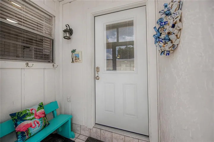 A screened in porch and entry to the unit.