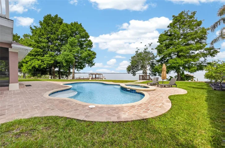 Artistically designed patio area with heated pool and raised spa