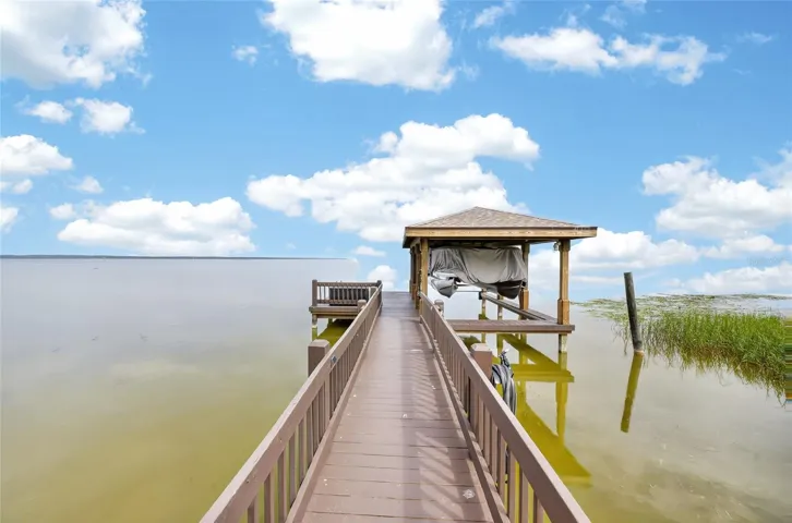 Boat dock with covered boat lift. New roof on the boat lift 2025