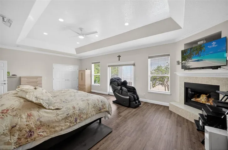 Primary bedroom with lovely corner fireplace and 2 closets. Plenty of lake views from the bedroom windows and from the balcony