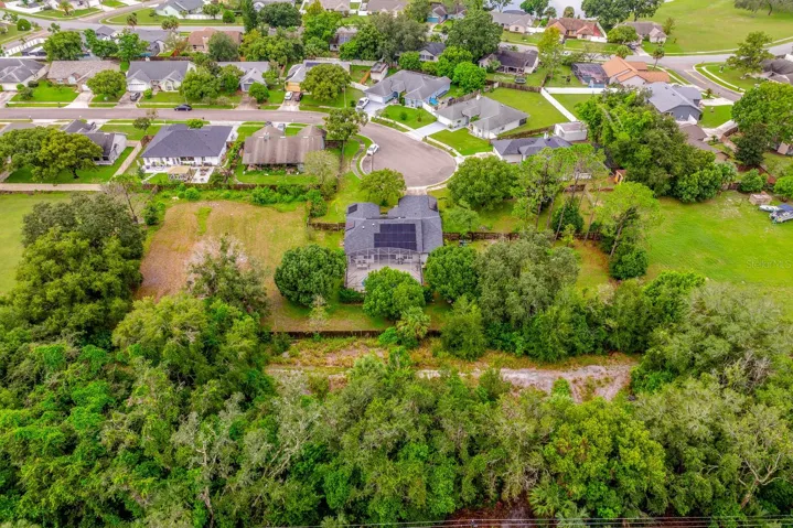 Over an acre surrounded by mature trees.