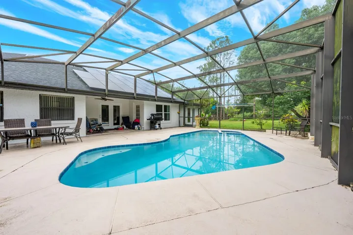 Covered lanai overlooks a private pool and spa.