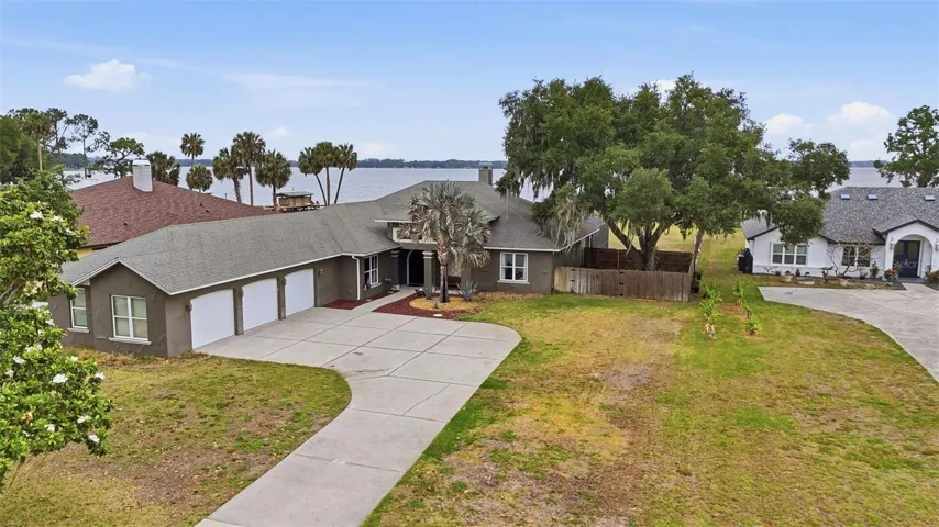 Front Exterior Aerial with Lake Dora