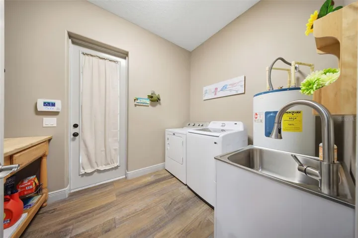 Interior Laundry room with Laundry sink and additional refrigerator