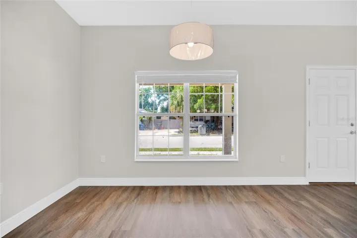 Open floor plan - new flooring. Dining area with new lighting