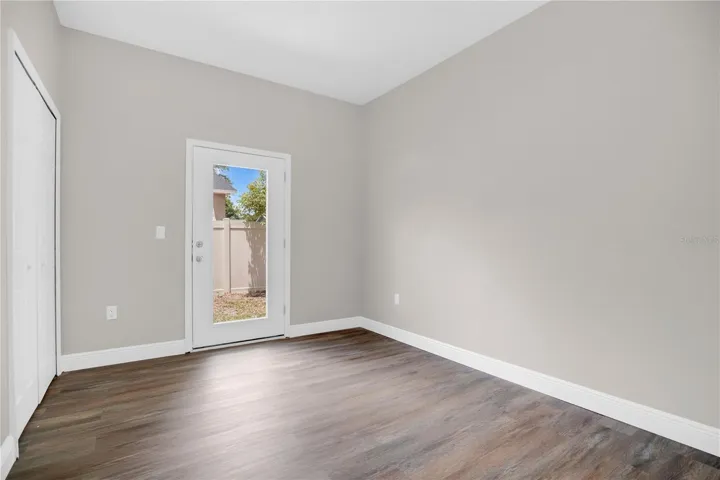 Bedroom 2 with access to the backyard and full size window for plenty of natural light