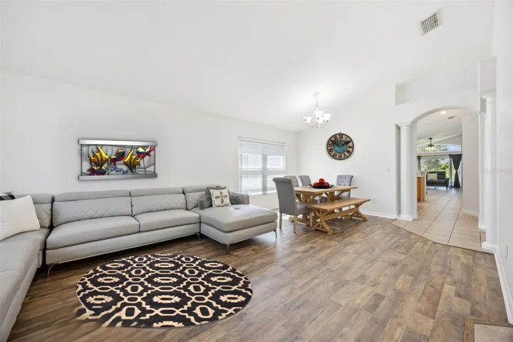 Formals lead to Kitchen and Primary Bedroom hallway through the Decorative Arches. Virtually Accessorized.