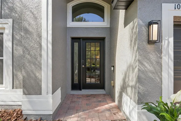 Covered Porch with French Door, Side Light and Decorator Window adds wonderful light to this home.