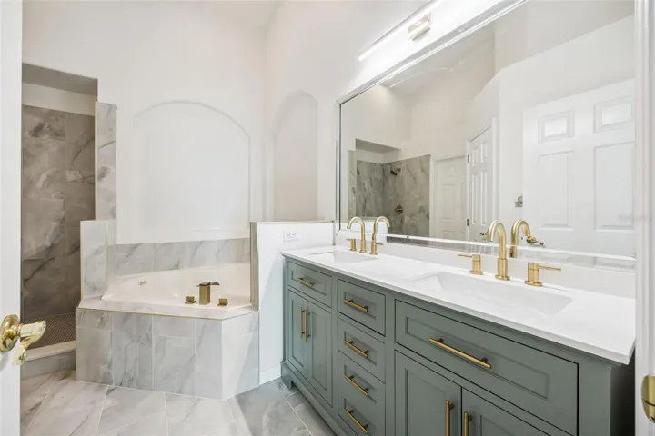 Newly installed Vanity Featuring Gold Hardware and lots of drawers!