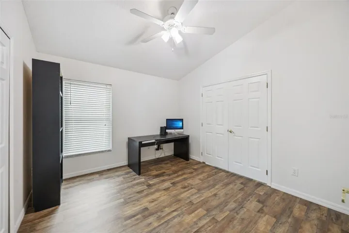 Bedroom 4 with Double Doors to the Primary Suite.