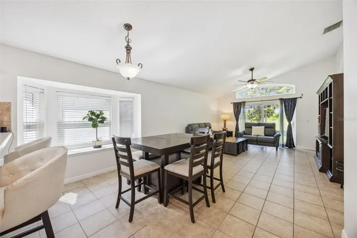 Open Informal Dining to the Family Room, Vaulted Ceilings and Bay Window with Bench.