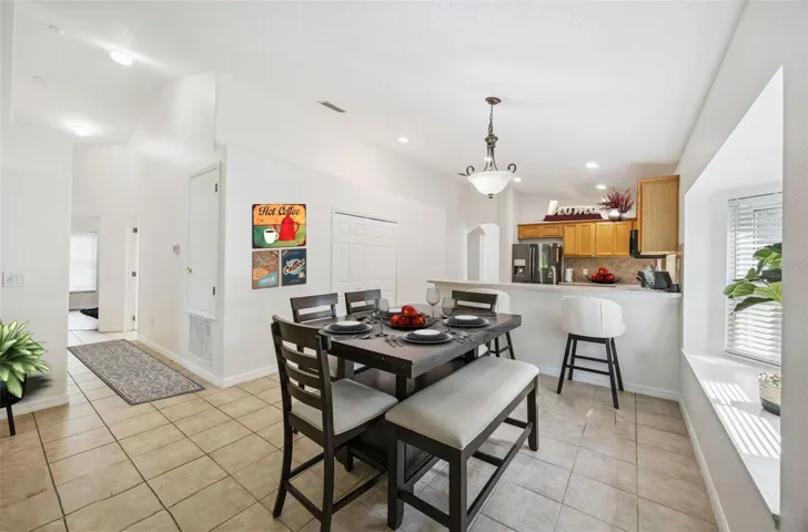 Virtually Accessorized Informal Dining with hallway to the Spare Bedrooms. Dual Closet Pantry offers excellent storage.