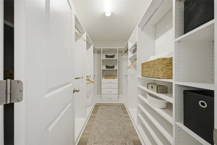 enormous custom walk in closet in primary
