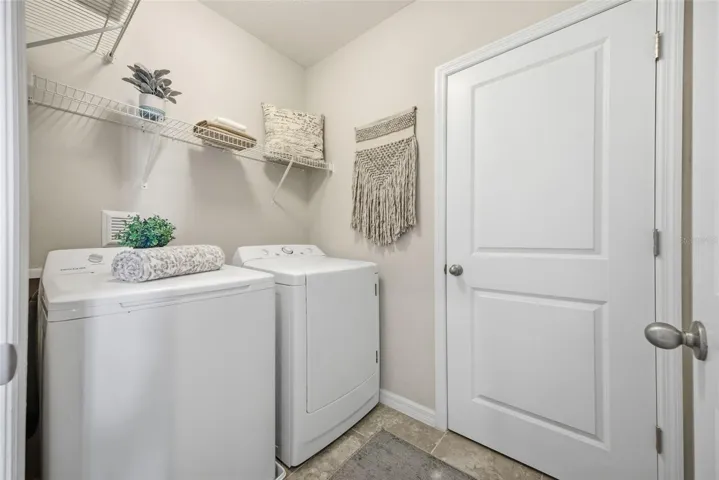 inside laundry room with storage