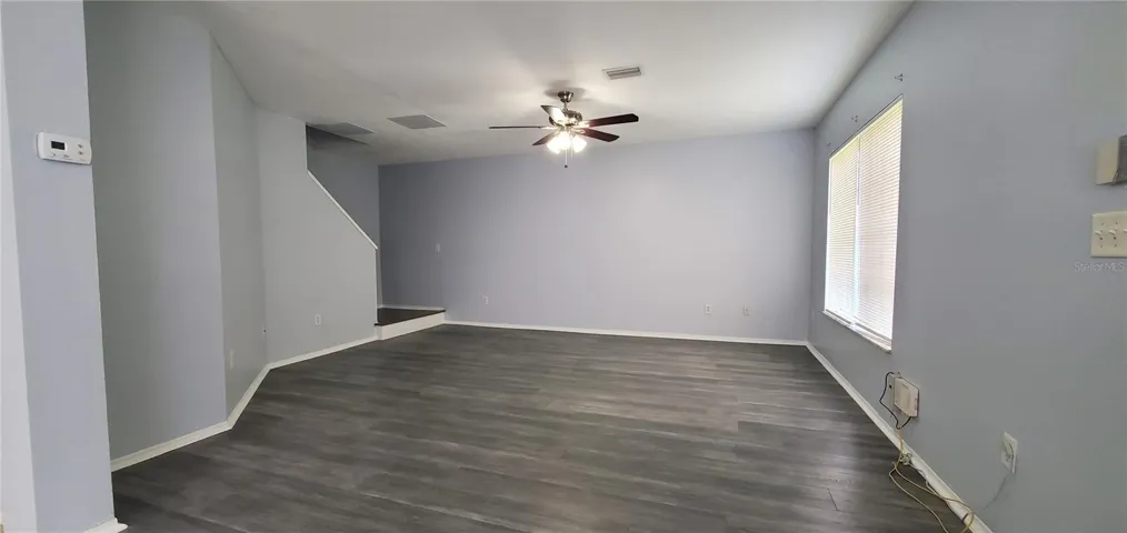 Living Room with Ceiling Fan and New Blinds.