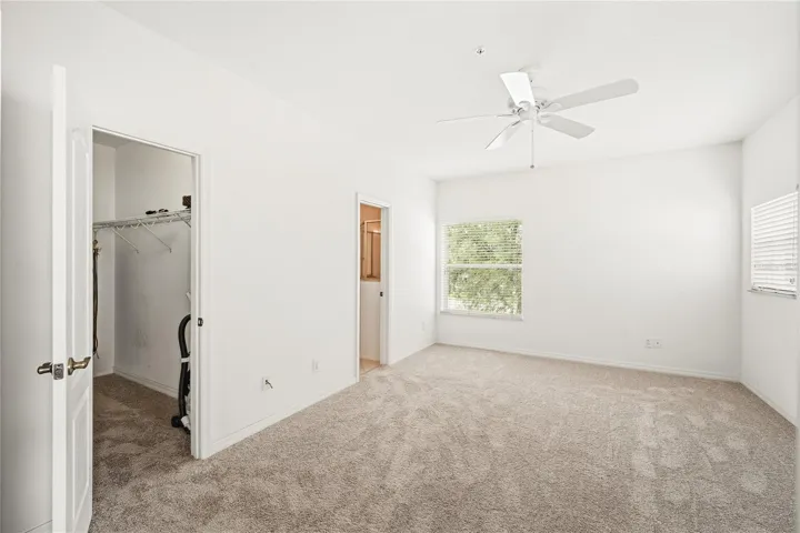 Primary bedroom with walk-in closet and ensuite bath.  This end unit townhome offers abundant natural light with extra windows