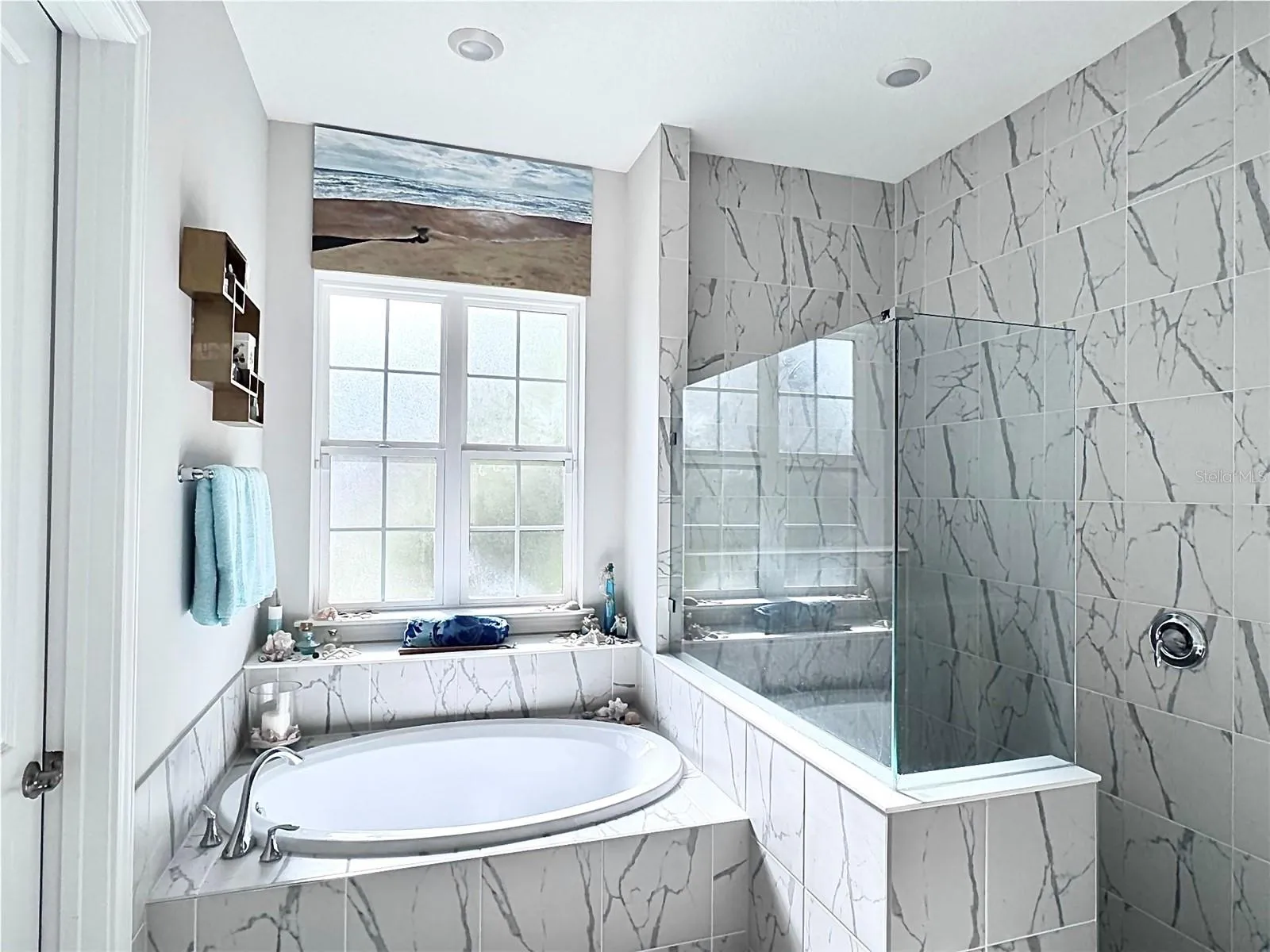 Primary Bath ensuite with soaking tub, frameless shower for two, and double vanities.