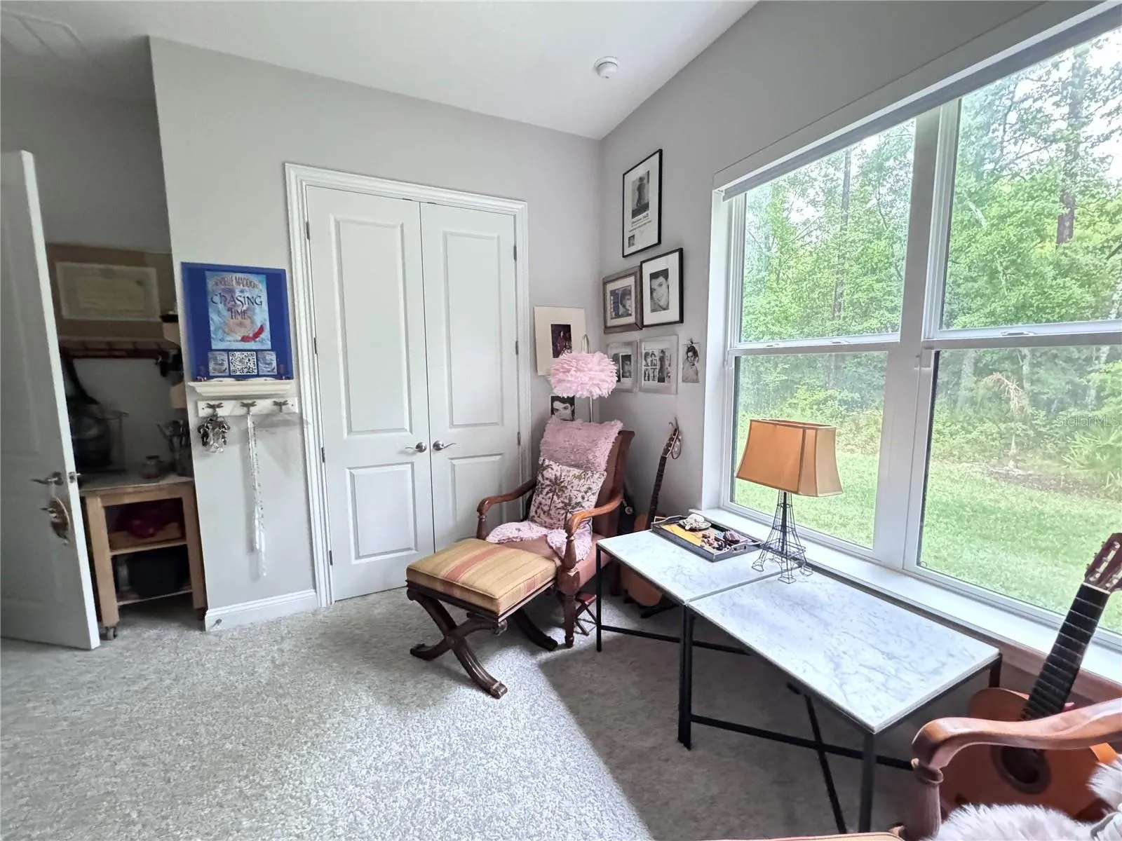 bedroom 2 used as studio with large window overlooking yard and preserve.