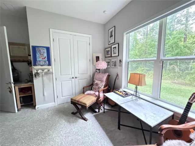 bedroom 2 used as studio with large window overlooking yard and preserve.