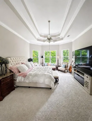 Primary Bedroom with  bay window sitting area & double tray coffered ceilings.