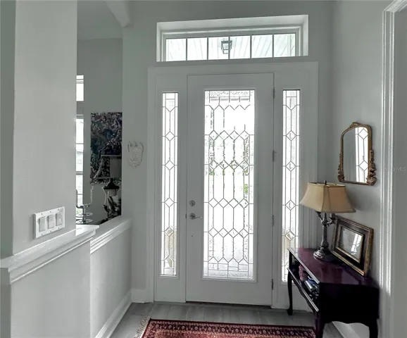 Leaded glass door entry with soaring14' ceilings and 16' double tray ceilings.