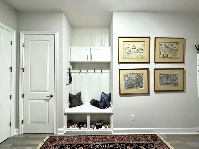 Extra large laundry room off the garage with drop zone, closet and sink cabinet.