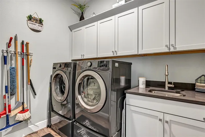 Inside laundry room with built ins and utility sink