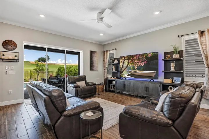 Family room with sliders to pool and golf course view