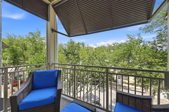 Balcony off Living Room with ceiling fan and coach light