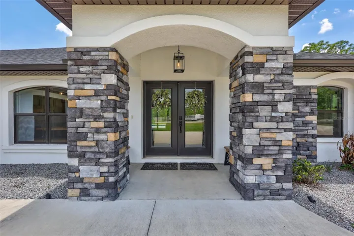 Beautiful Stone Accent Entrance with Covered Front Porch Creating Exceptional Curb Appeal