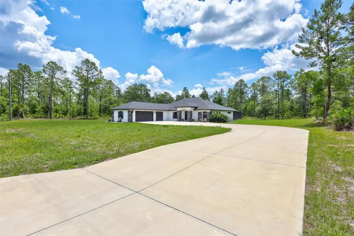 Oversized Driveway Leads to Spacious 3 Car Garage with Epoxy Floors & Plenty of Storage Space