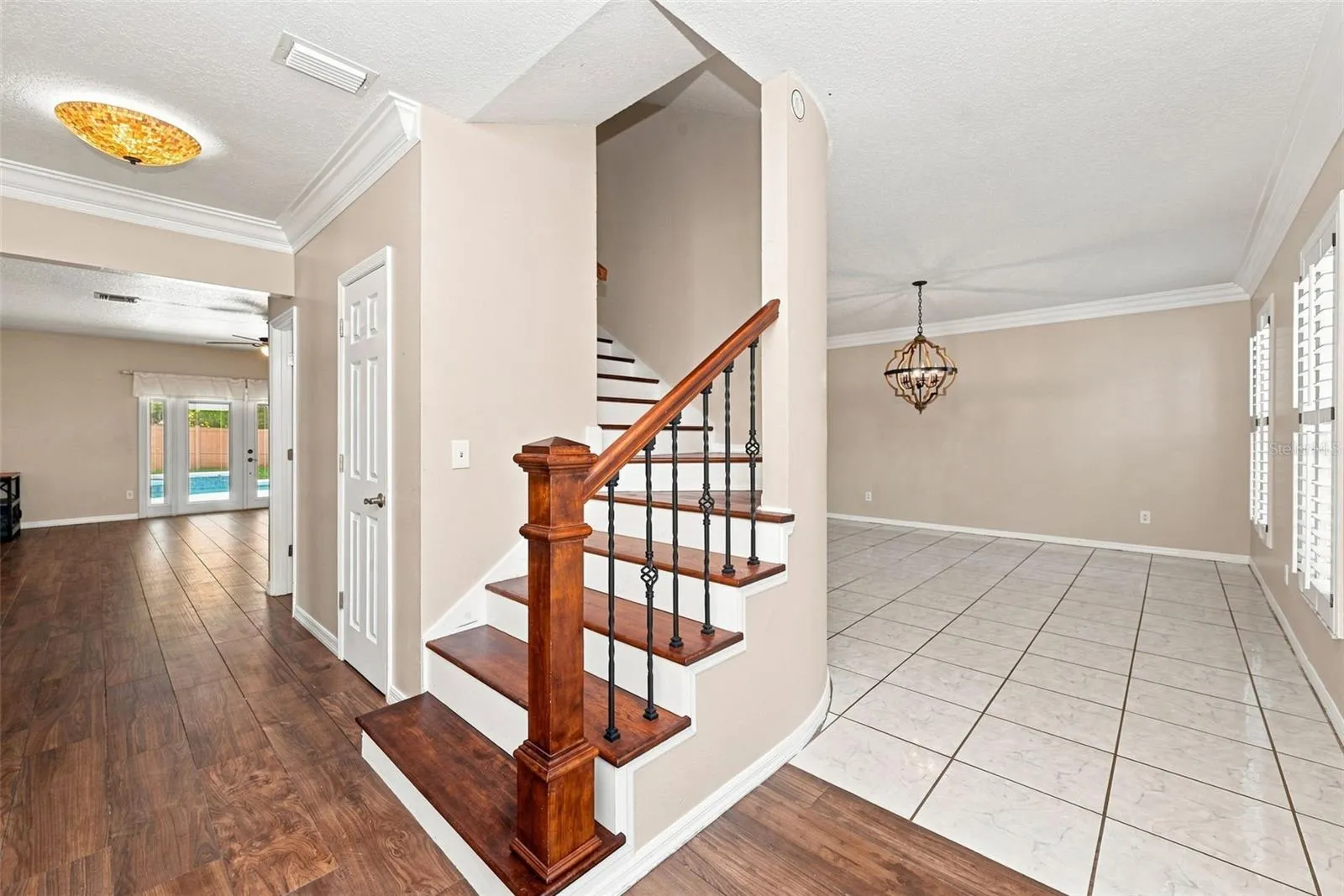 Grand Foyer Staircase with under stair storage + guest bath