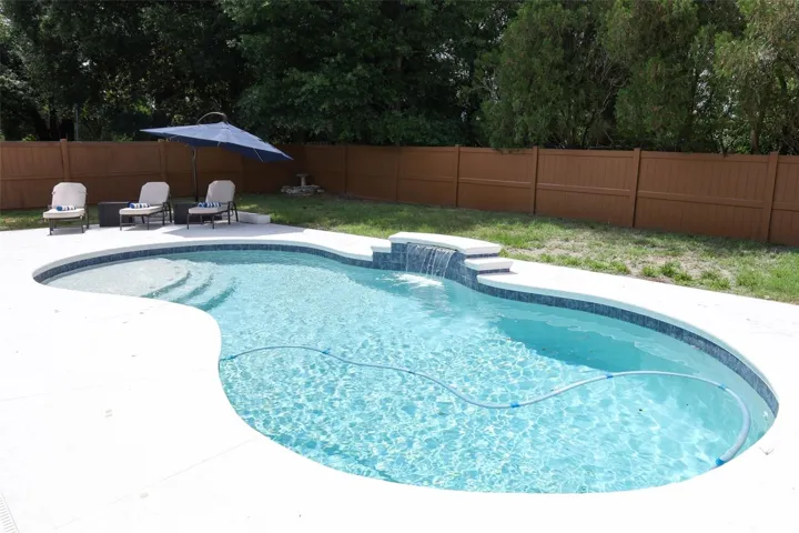 Saltwater Solar Heated Pool with Tanning Shelf and water feature