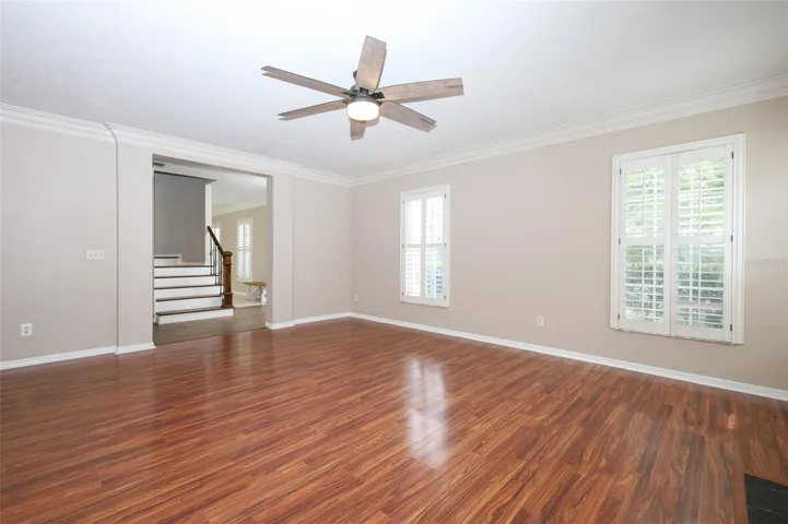 Living Room with Plantation Shutters + Crown Moulding