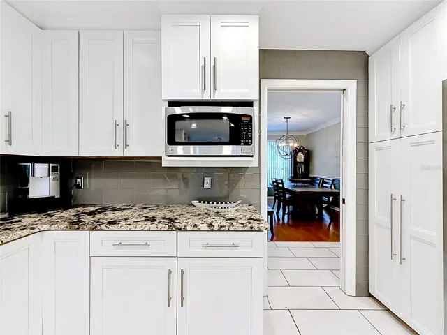 This kitchen marries beauty and practicality perfectly, boasting abundant storage for all your culinary needs