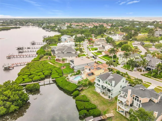 Elevated above the beauty, this drone shot presents a captivating perspective of the waterfront home, framed by flourishing mangroves and the tranquil waters—nature’s masterpiece at its finest.