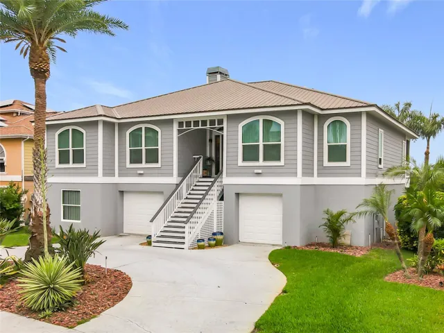 Welcome to your waterfront oasis! This captivating front exterior showcases beautiful landscaping and offers extra parking, perfect for embracing the joys of intercoastal living