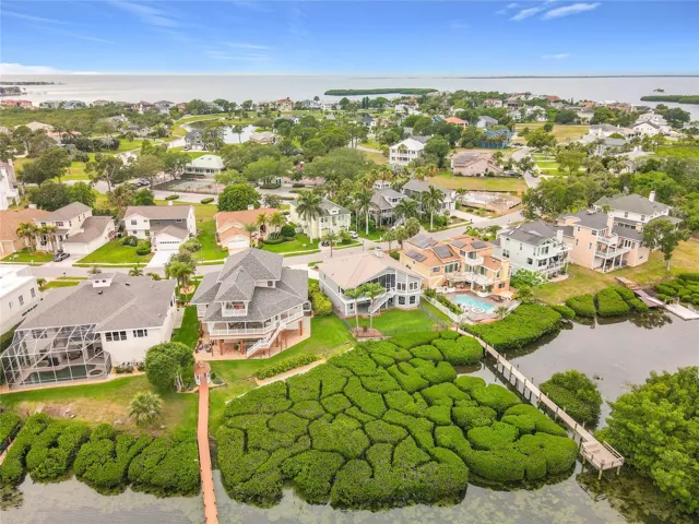 Get a bird's-eye view of this beautiful waterfront property, harmoniously surrounded by vibrant mangroves—an idyllic escape that embodies the tranquility of life by the water.